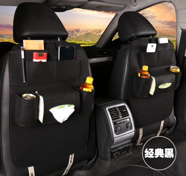 Car back seat organizer with multiple pockets and items in a vehicle interior, mordenstore. 
