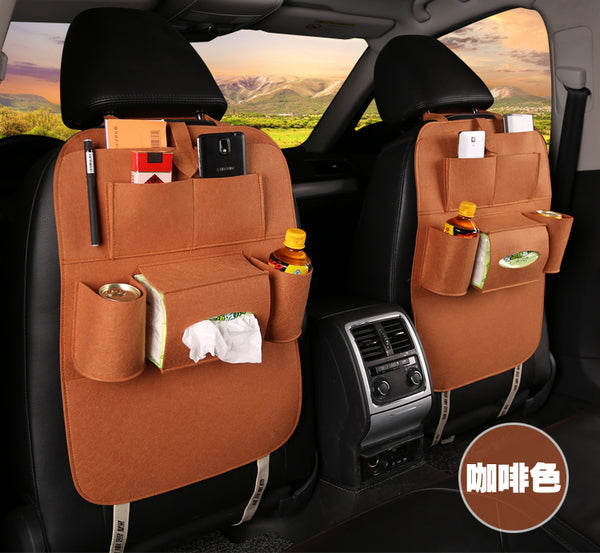 Car back seat organizer with multiple pockets filled with items, placed inside a vehicle, mordenstore. 