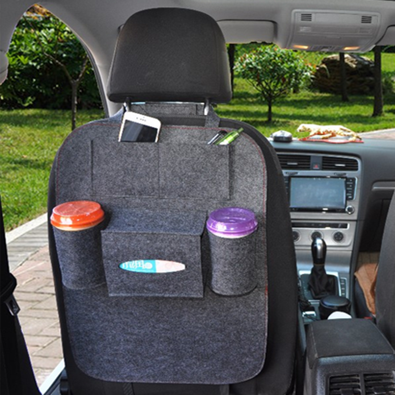 Car seat organizer with multiple pockets and cup holders in a car interior, mordenstore. 