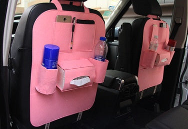 Pink car seat organizer with multiple pockets and bottles inside a vehicle, mordenstore. 