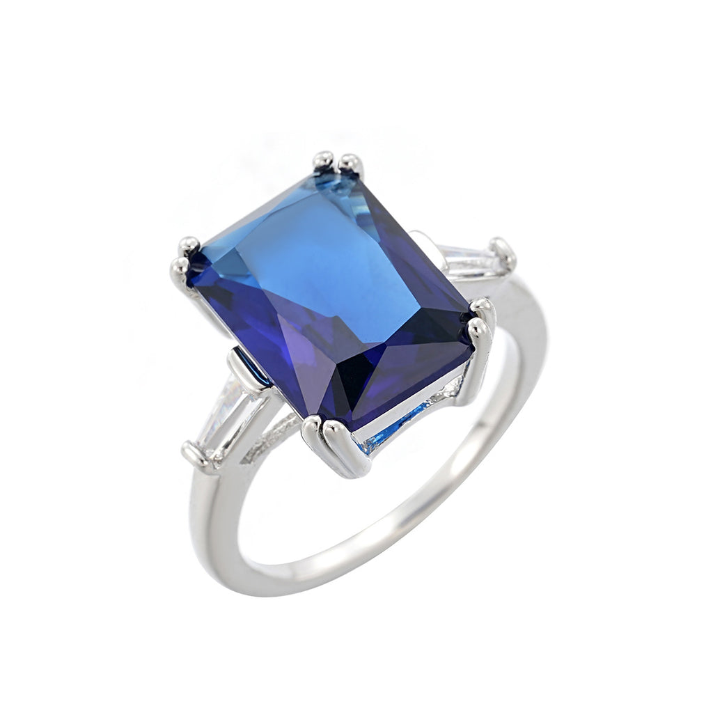 Silver ring with a blue gemstone on a white background, mordenstore. 