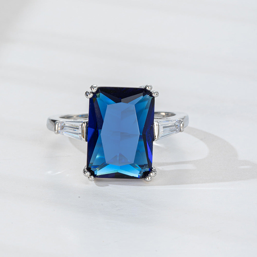 Ring with a blue gemstone on a white background, mordenstore. 