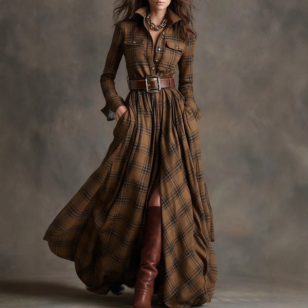 Woman wearing a long brown plaid dress with a belt and high boots against a gray background