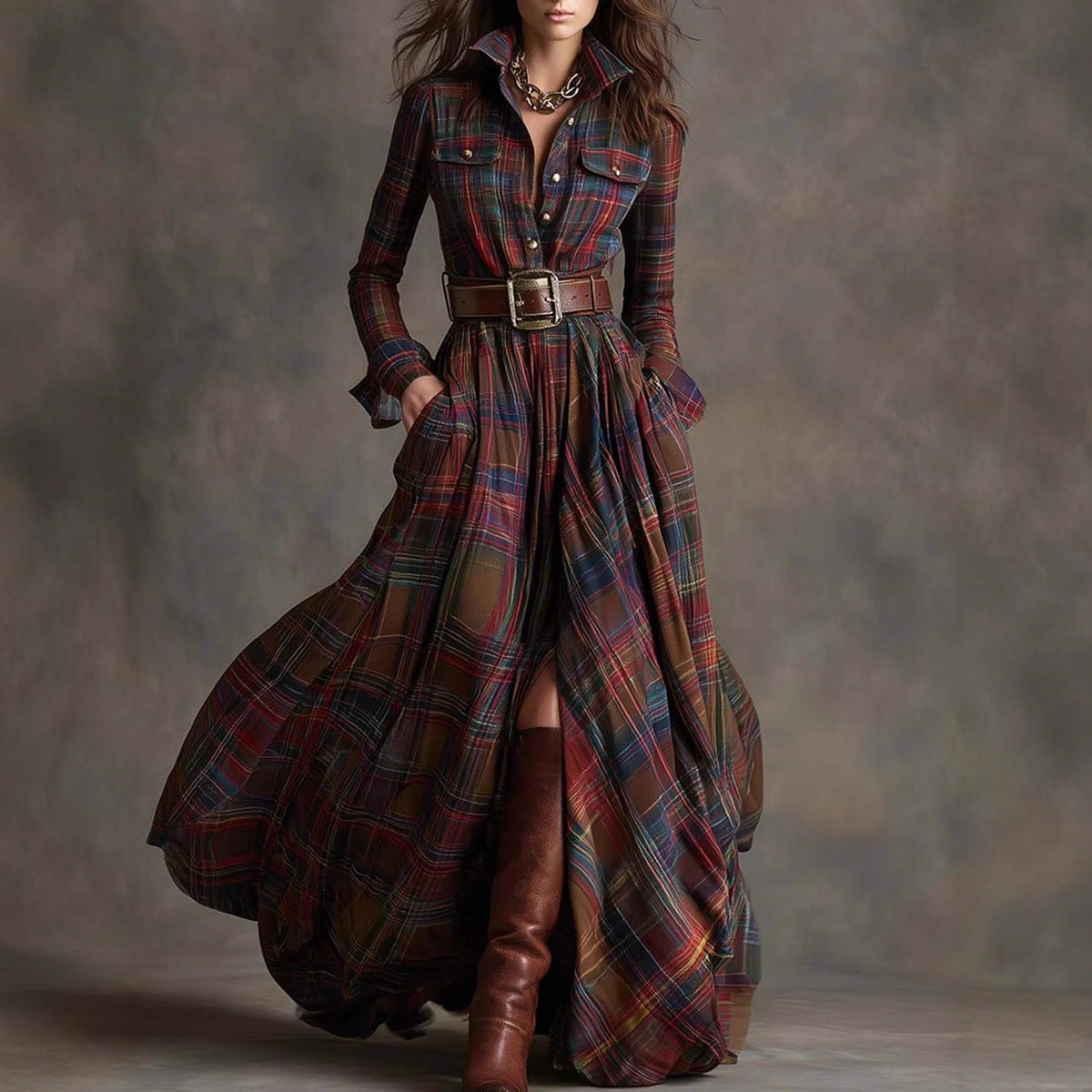 Woman wearing a long plaid dress with brown boots against a neutral background