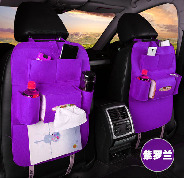 Purple car seat organizer with multiple pockets and a tissue holder inside a vehicle.